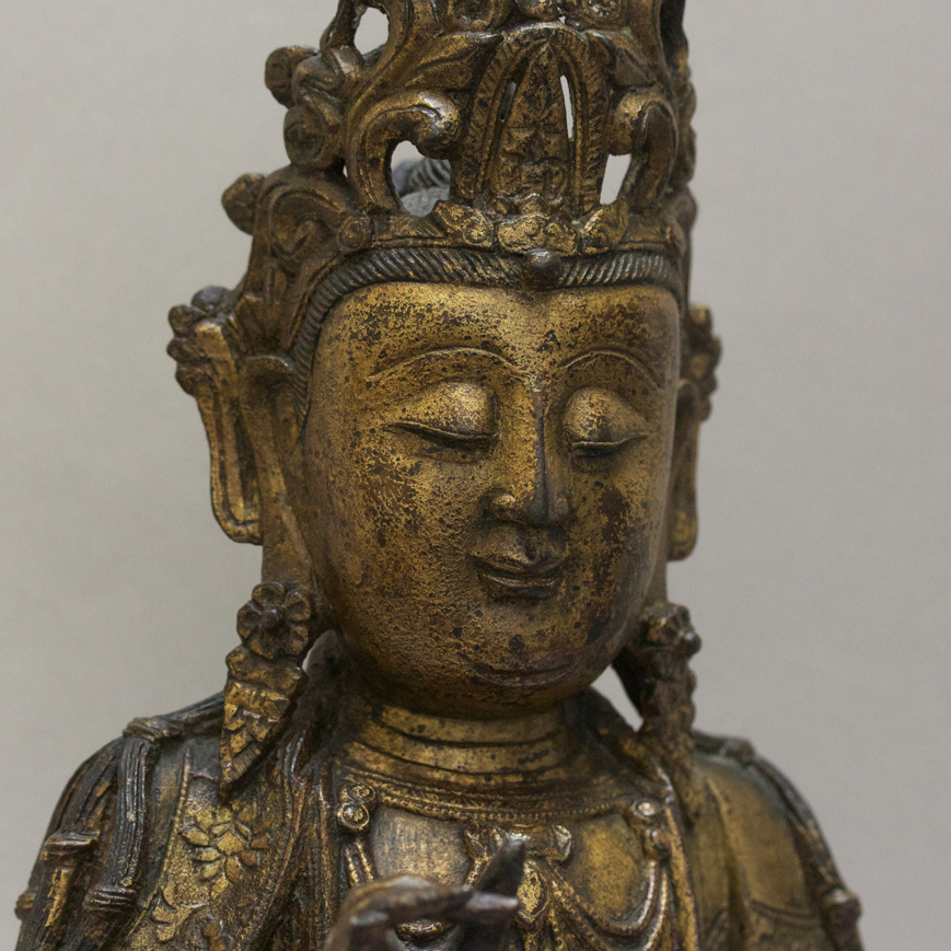 A GOLD LACQUERED BRONZE GUANYIN FIGURE