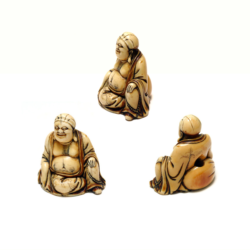 AN IVORY NETSUKE FIGURE OF HOTEI