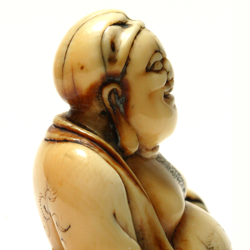 AN IVORY NETSUKE FIGURE OF HOTEI